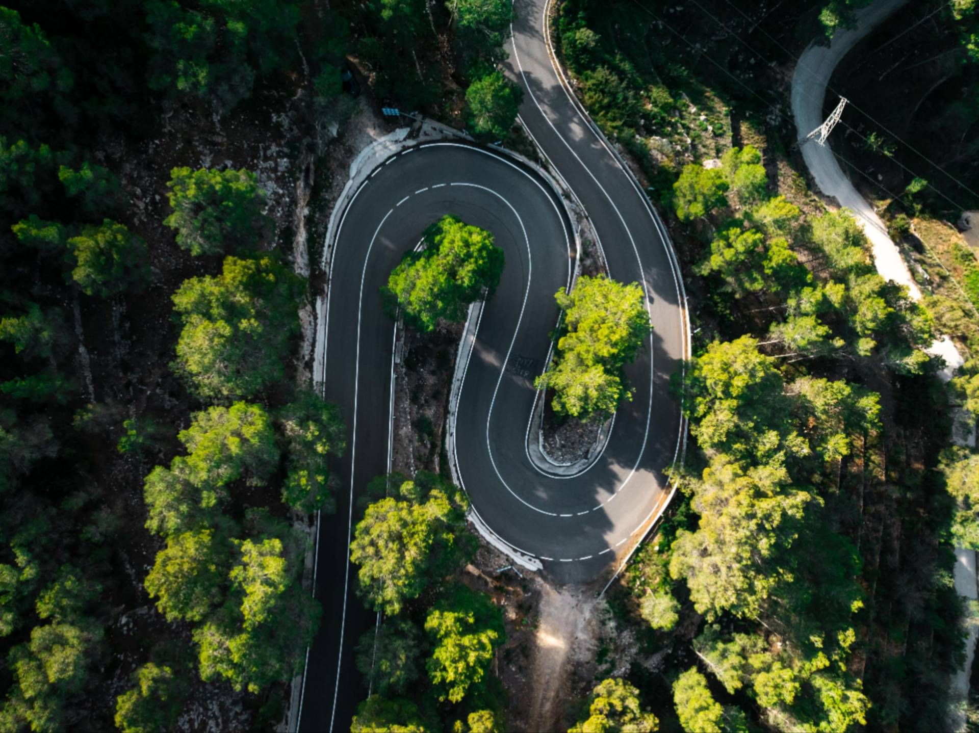 Winding scenic road from a Supercar Driver Club tour, ideal for supercar enthusiasts seeking tight turns and breathtaking driving routes.